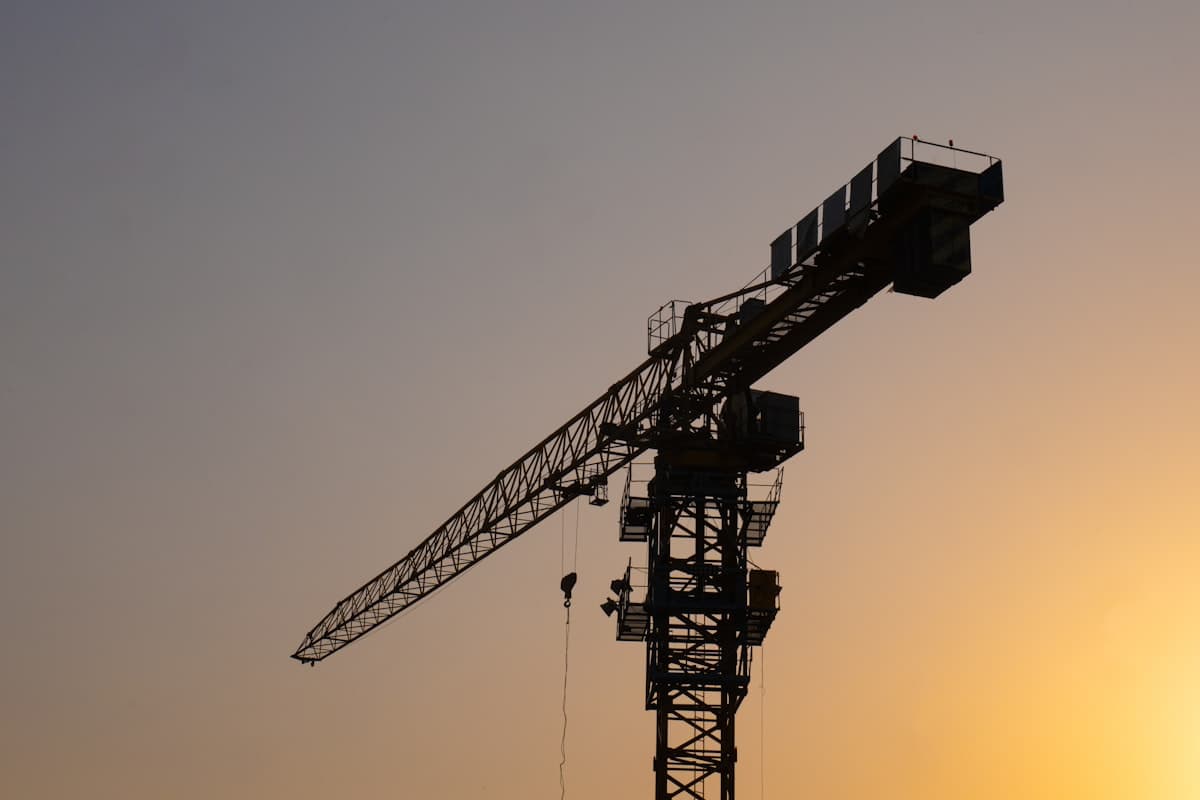 Construction crane against a golden sky
