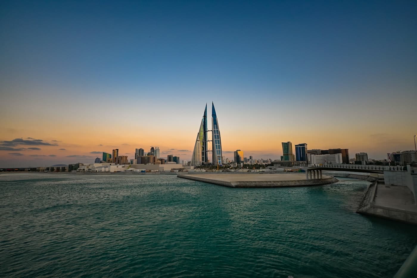 Bahrain World Trade Center rising above teal water